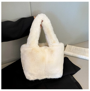 Close-up of a white plush faux fur tote bag showing the soft texture and integrated handles
