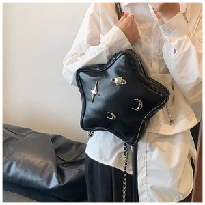 Close-up of black star-shaped crossbody bag with silver celestial rivets and chain strap
