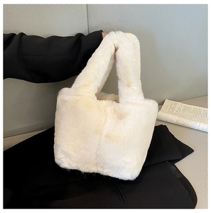 Close-up of soft beige faux fur handbag showing fluffy plush texture and tote handle