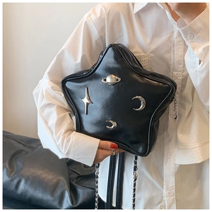 Detail of star-shaped PU leather bag with cosmic metal ornaments and chain strap