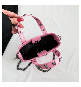 Pink gothic handbag interior view with metal rivets, magnetic closure and chain strap