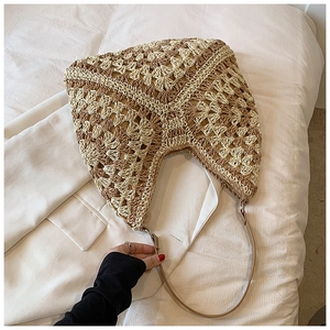 Detail of hand-woven hobo bag with contrast geometric patterns and slim leather strap