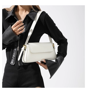Detail of white leather square bag with golden adjustable buckle on a shoulder strap