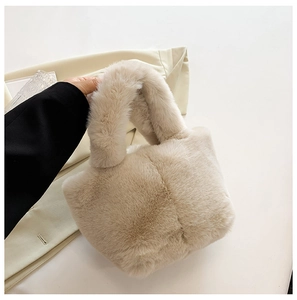 Close-up of fluffy off-white plush handbag featuring thick faux fur texture and sturdy handle