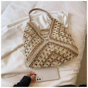 Close-up of bohemian woven hobo bag showing crochet texture and leather shoulder strap