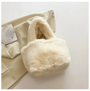 Detail of soft cream plush bucket handbag with fluffy texture and single handle design