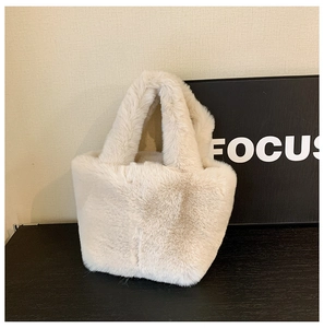 Detail of plush off-white faux fur tote bag with soft fluffy texture for winter fashion