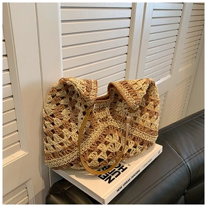 Detailed macro of handmade woven tote bag with contrast crochet texture and leather straps