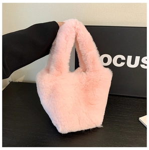 Detail of soft pink faux fur tote bag showing the plush texture and U-shaped structure