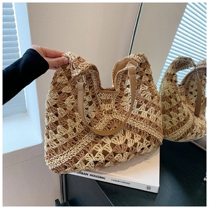 Detail of hand-crocheted straw tote bag with mixed beige brown knit and PU leather strap