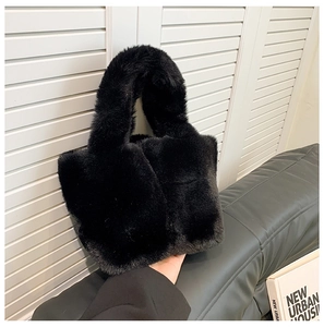 Close-up of premium black faux fur texture on a luxury plush bucket handbag for women