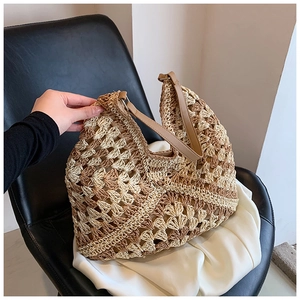 Detailed close-up of handmade woven straw bag featuring contrast hollow wave texture