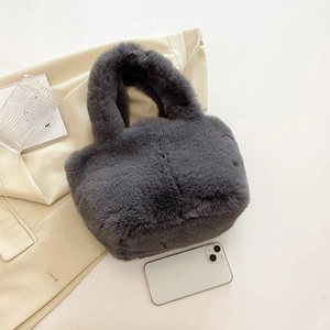 Detailed overhead view of a plush grey faux fur handbag with a soft, round bucket shape