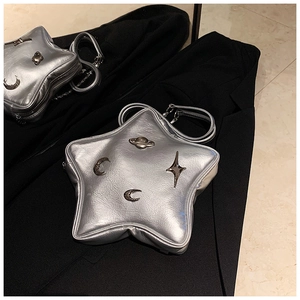 Detailed view of silver star-shaped crossbody bag featuring embossed celestial metal accents