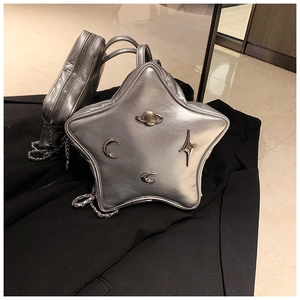 Detail of silver star-shaped Y2K bag with metallic PU leather and celestial charms