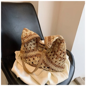 Close-up of contrast woven straw bag with hollow crochet texture and leather strap