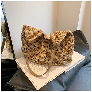 Detail of hand-woven straw tote with gradient tones and premium leather strap