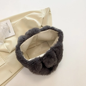 Detailed interior of dark grey faux fur handbag with magnetic closure and soft lining