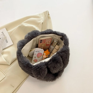 Deep grey plush bucket bag interior showing capacity for cosmetics and phone storage