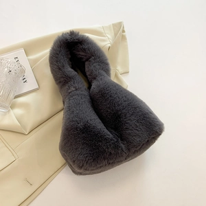 Detailed texture of dark gray faux fur plush handbag on professional studio background