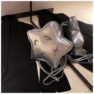 Detail of silver star-shaped Y2K crossbody bag with metallic Saturn ornaments and chain