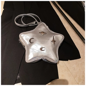 Macro detail of silver star-shaped leather crossbody bag with celestial metal ornaments