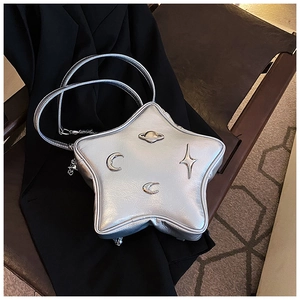 Detailed shot of star-shaped silver metallic bag with celestial metal ornaments and chains