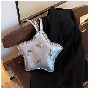 Detailed macro view of silver star-shaped bag with metallic crackle texture and planet charms