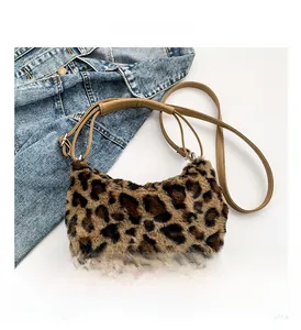 Detail shot of leopard print faux fur texture and slim leather shoulder strap on the moon bag