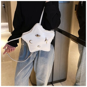 White star-shaped crossbody bag with metallic Saturn charms and Y2K aesthetic chain strap