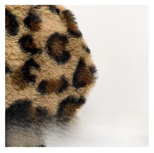 Close-up of premium leopard print faux fur texture with soft plush fibers and dense pile