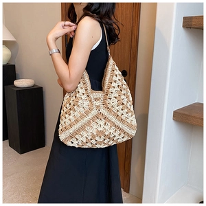 Detail of hand-woven crochet shoulder bag with brown geometric patterns and slim straps