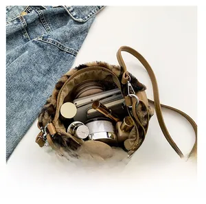 Internal capacity display of leopard print plush bag with cosmetics and leather strap