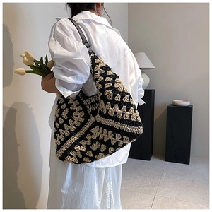 Detailed view of the bohemian crochet tote with geometric black and beige patterns