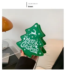 Detail of Christmas tree shaped green crossbody bag with Merry Christmas print and chain
