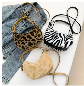 Detailed plush crescent bags in leopard, zebra, and beige textures with leather straps