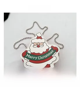 Detail of Santa Claus cross-body bag featuring Merry Christmas text and silver chain