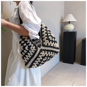 Detail of the woven tote bag featuring geometric patterns and a contrast color design