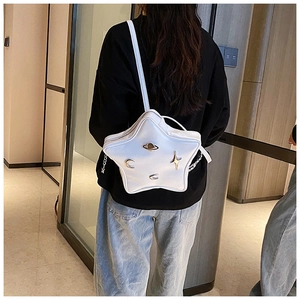 Close-up of white star-shaped shoulder bag featuring silver cosmic metal ornaments