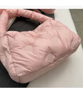 Detail of soft puffy winter down cotton bag with pink quilted fabric and thick handle
