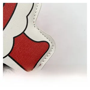 Macro shot of textured red and white faux leather with premium white stitching detail