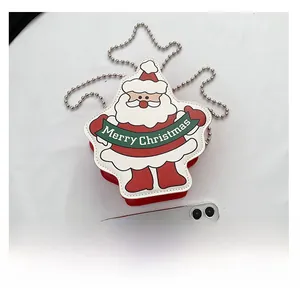 Detailed view of mini Christmas Santa chain bag with phone for size reference