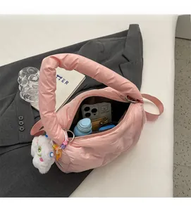 Detail shot of pink quilted puffer bag interior showing spacious storage for essentials