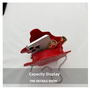 Internal view of red star-shaped crossbody bag showing phone and lipstick storage