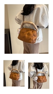 Detailed view of bronze quilted puffer bag with plush doll charm and handle