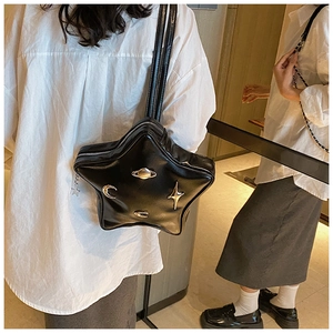 Close-up of star-shaped PU leather crossbody bag with celestial metal ornaments