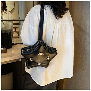 Star shaped black leather crossbody bag with gold celestial moon and planet ornaments