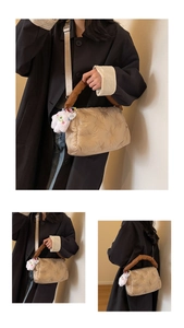 Detailed quilted puffer crossbody bag with a white plush heart charm and gold strap