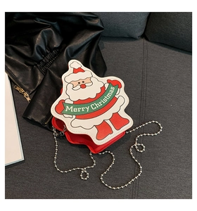 Detail view of red Santa Claus crossbody bag with silver bead chain and holiday motif