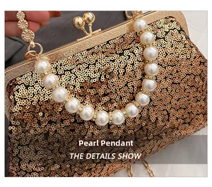 Detail of vintage gold sequin evening bag featuring ornate metal frame and pearl handle